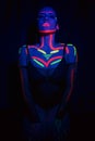 Model woman in neon light, beautiful model girl with fluorescent makeup, art design of disco dancer dancing in uv light Royalty Free Stock Photo