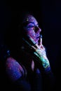 Model woman in neon light, beautiful model girl with fluorescent makeup, art design of disco dancer dancing in uv light Royalty Free Stock Photo