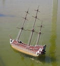 Model of the wooden antique sailing ship on wated Royalty Free Stock Photo