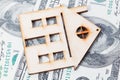 Model of wooden house with dollar bills. House building, loan, real estate, cost of housing or buying a new home concept. Royalty Free Stock Photo