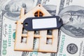 Model of wooden house with dollar bills. House building, loan, real estate, cost of housing or buying a new home concept. Royalty Free Stock Photo