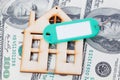 Model of wooden house with dollar bills. House building, loan, real estate, cost of housing or buying a new home concept. Royalty Free Stock Photo