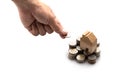 Modeled wooden house placed on a stack of coins