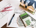 Modelhouse, calculator and US Dollars on construction planning Royalty Free Stock Photo