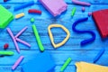 Modelling clay of different colors forming the word kids Royalty Free Stock Photo
