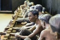 Models of detained prisoners by lock their foot ankle on something like wooden console at Hoa Lo Prison Museum in Hanoi, Vietnam