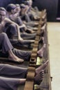 Models of detained prisoners by lock their foot ankle on something like wooden console at Hoa Lo Prison Museum in Hanoi, Vietnam