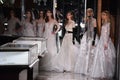 Models pose on the runway wearing Reem Acra at Tiffany and Co.