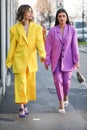 Models wear a purple and a yellow suit during the Gucci fashion show at the women`s fashion week fall / winter 2020 in Milan