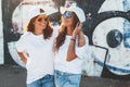 Models wearing plain tshirt and sunglasses posing over street wa