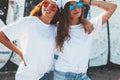 Models wearing plain tshirt and sunglasses posing over street wa