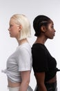 Models with white and dark skin posing together for diversity article