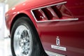 Detail of Ferrari 275 GTS red sports car in Museum Enzo Ferrari Modena focused on Pininfarina logo Royalty Free Stock Photo