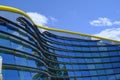 Modena, Italy: Exterior of the glass blue buildings of the Ferrari Museum and its yard with visitors.