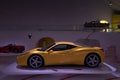 Modena, Italy - July 14, 2021: Yellow racing Ferrari 458 model high-performance Italian sports car in a dark hangar in Museo Casa