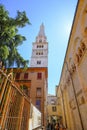 Modena, Italy: Tower Ghirlandina and the facade of the Duomo Modena across the blue sky from beneath on the square piazza della To