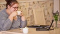 Moderately obese businesswoman sitting in a cafe while holding coffee