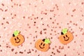 Modern abstract pastel pink background with round confetti and cartoon Halloween pumpkins. Great design for any purposes