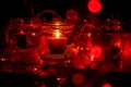 Modern advent wreath made of four glass jars, fake snow and red candles. Christmas decoration Royalty Free Stock Photo