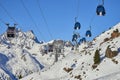 Modern aerial tramway in Austrian Alps ski resort. Highland cable car leads between hills from village to ski slope