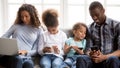 African American family relax at home using gadgets Royalty Free Stock Photo