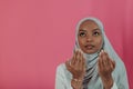 Modern African Muslim woman makes traditional prayer to God, keeps hands in praying gesture, wears traditional white Royalty Free Stock Photo