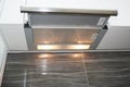 Modern air exhauster kitchen fan or Range Hood. Stainless Steel Chimney Hood with Metal Pipe. Cooker Hood.