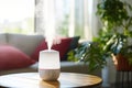 Modern air humidifier sitting on a table in living room Royalty Free Stock Photo