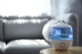 Air humidifier on table in living room. Space for text Royalty Free Stock Photo