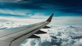 Modern Aircraft Wing Flying Through Cloudy Blue Sky