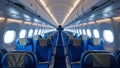 Modern airplane cabin interior with blue seats and spacious design., Royalty Free Stock Photo