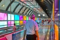 Modern airport moving walkway indoor with travelers. Transport corridor