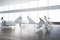 Modern airport waiting area interior with reflections on floor, decorative plants, benches, window with aircraft view and daylight