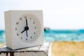 Modern alarm clock on beach Royalty Free Stock Photo