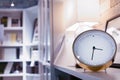 Modern alarm clock in home library and living room with blurred bookshelf background at night time Royalty Free Stock Photo