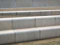 Modern angled outdoor steps with rounded corners int textured grey and brown colors