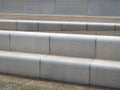 Modern angled outdoor steps with rounded corners int textured grey and brown colors