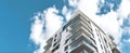 The modern apartment building featuring sleek design against a bright blue sky. AI generated image Royalty Free Stock Photo