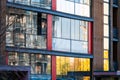 Modern apartment building wall with large windows close-up, reflections in the glass Royalty Free Stock Photo