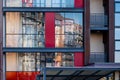 Modern apartment building wall with large windows close-up, reflections in the glass Royalty Free Stock Photo