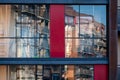 Modern apartment building wall with large windows close-up, reflections in the glass Royalty Free Stock Photo