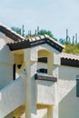 Modern apartment building with white stucco exterior with red tiles in suburban part of the neighborhood downtown Royalty Free Stock Photo