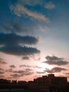 Modern apartment buildings in large city under sky with white clouds at sunset in nice spring evening stock Royalty Free Stock Photo