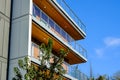 Modern apartment buildings on a sunny day with a blue sky. Facade of a modern apartment building with glass balconies