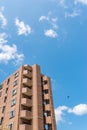 Modern apartment, hotel building on blue sky background from worm eyes view Royalty Free Stock Photo