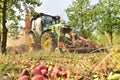 Modern apple harvest with a harvesting machine on a plantation with fruit trees Royalty Free Stock Photo