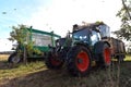 Modern apple harvest with a harvesting machine on a plantation with fruit trees Royalty Free Stock Photo