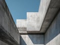 Modern architectural design featuring stark concrete structures with geometric shapes casting sharp shadows under a clear blue sky Royalty Free Stock Photo