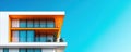 Modern architectural design featuring vibrant orange balcony against clear blue sky Royalty Free Stock Photo