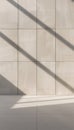 Modern architectural facade with diagonal light and shadow patterns on stone tiles Royalty Free Stock Photo